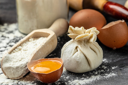 Raw Khinkali with meat, on a wooden board with flour, semi-finished products dumplings cooking khinkali. Georgian dumplings.の写真素材