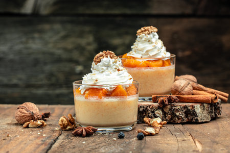 Creamy dessert with pumpkin mousse on a wooden background. place for textの写真素材