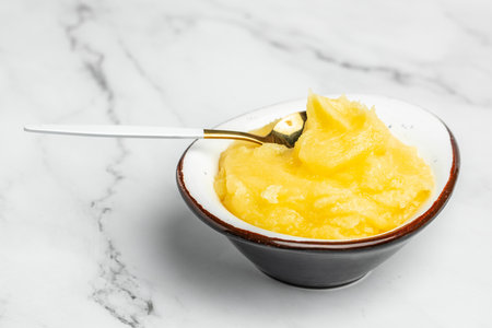 Homemade Melted ghee clarified butter. Bio Ayurveda Lactose free high quality butter on a light background. place for text, top view.の写真素材