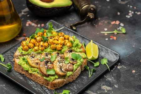 vegetarian sandwiches with avocado guacamole, chickpeas, spices and microgreensの写真素材
