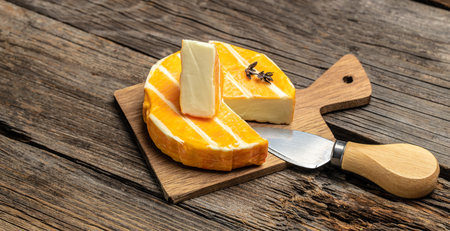 cream Round brie or camembert cheese on a wooden background. Long banner format place for text, top view.の写真素材