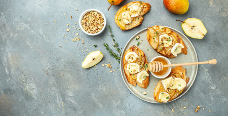 bruschetta with baked pear, honey, walnut and brie camembert cheese, Long banner format. top view,の写真素材