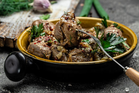 Stewed chicken stomach in pan. Traditional Korean spicy chicken meat on a dark background. top view.の写真素材