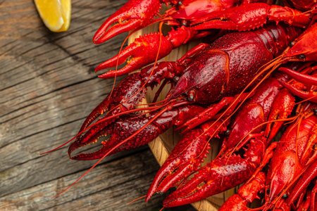 Red crayfish with lemon on a wooden background. banner, menu, recipe place for text, top view.の写真素材