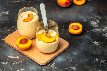 Peach drink in a glass with milk on a light background, Healthy eating. Breakfast, snack, Restaurant menu, dieting, cookbook recipe top view,の写真素材