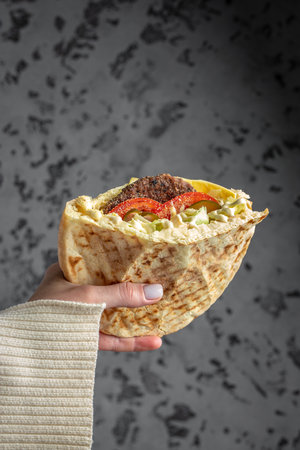 Woman hands holding doner kebab. fast food take away. copyspace.の写真素材
