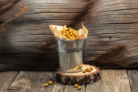 Roasted spicy chickpeas on wooden table background. Restaurant menu, dieting, cookbook recipe top view.の写真素材