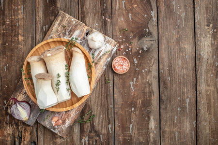 King Oyster mushrooms or Eringi on a wooden background, banner, menu, recipe place for text, top view,の写真素材