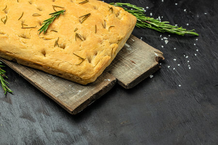 foccacia bread. olive oil and herbs on a dark background. banner, menu, recipe place for text, top view.の写真素材
