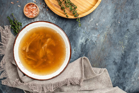 Bone broth made from pork knuckle in bowl. banner, menu, recipe place for text, top view.の写真素材