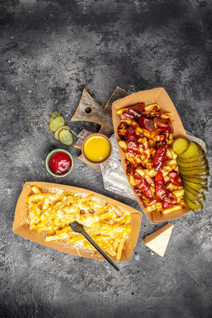fries food. Unhealthy tasty grilled french fries with cheese and bacon in paper plate, Street food,