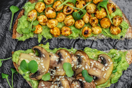 toast with avocado, roasted chickpeas and mushrooms on a dark background. superfood concept....
