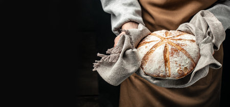 woman holding fresh bread from the oven, baking homemade sourdough bread. food preparation....