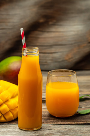 Fresh tropical fruit smoothie mango juice in a glass jar with a tube. place for text,の写真素材