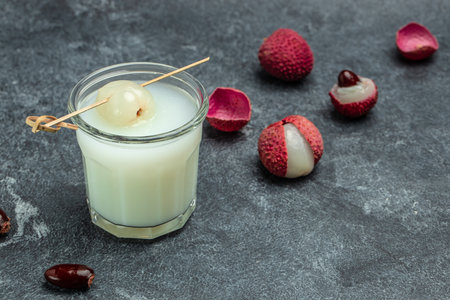 Lychee juice with fruits on a dark background, Restaurant menu, dieting, cookbook recipe top view,の写真素材