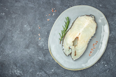 Raw steak of white Anarhichas fish sreak. banner, menu, recipe place for text, top view,