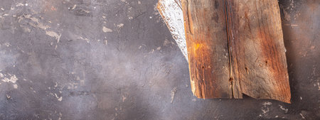 Wooden board on dark background, Long banner format. top view,