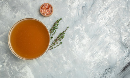 Bone meat pork broth in bowl on a light background. Long banner format. top view.の写真素材