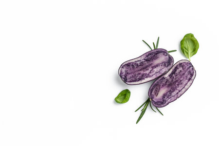 Raw cut purple sweet potatoes isolated on white background. Ipomoea batatas. Batata potatoes. Long banner format. top view.の写真素材