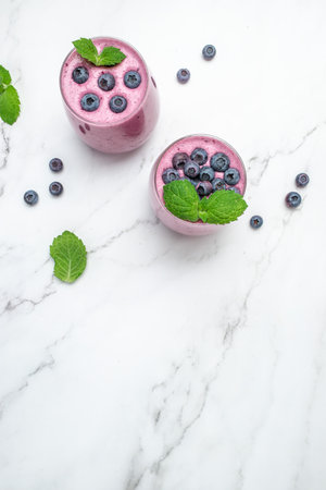 Bilberry yogurt cocktail on a light background. natural detox. vertical image. top view. place for text.の写真素材