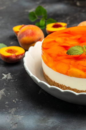 dessert peaches, cheesecake with peache jelly on white plate. Restaurant menu, dieting, cookbook recipe top view.の写真素材