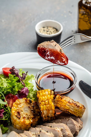 Green salad with chicken breast, grilled corn and sauce. Healthy fats, clean eating for weight loss.の写真素材