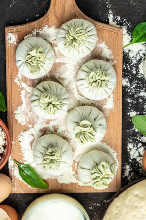 Khinkali with cheese and spinach. Raw semi-finished product dumplings. cooking khinkali. National...