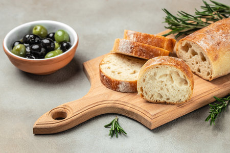 Ciabatta Bread with olive oil and olives. Food recipe background. close up.の写真素材