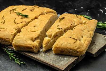 foccacia bread. olive oil and herbs on a dark background. banner, menu, recipe place for text, top view.の写真素材