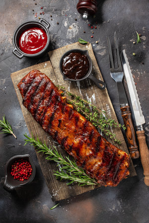hot grilled spare ribs BBQ served fresh tomatoes. Restaurant menu, dieting, cookbook recipe top view.の写真素材