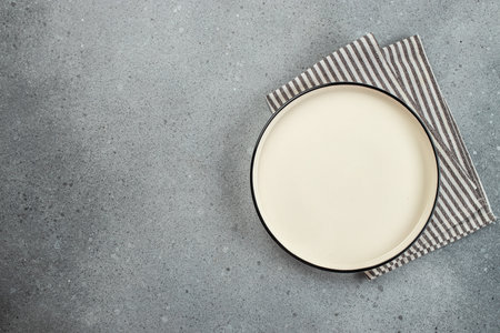 Empty plate with napkin on light table. food cooking background. top view.の写真素材
