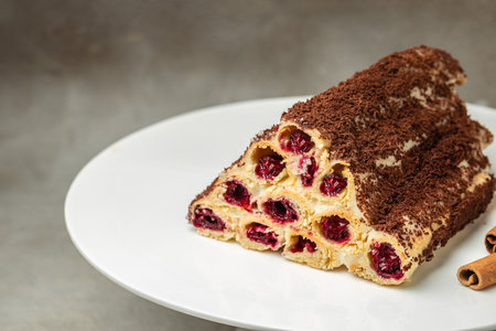 triangular cake with cherry on plate. Food recipe background. close up.