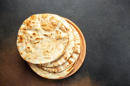 pita bread on a wooden board. Traditional Arabic food. banner, menu, recipe place for text, top...