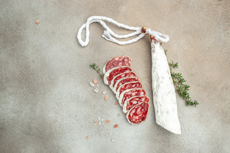 Slices of delicious spanish sausage fuet on a light background. banner, menu, recipe place for text, top view,の写真素材