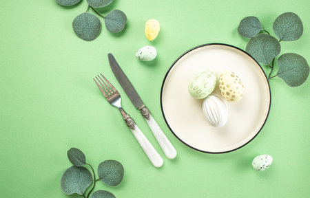 easter plate with Easter egg green leaves on green background. Happy Easter holiday concept.