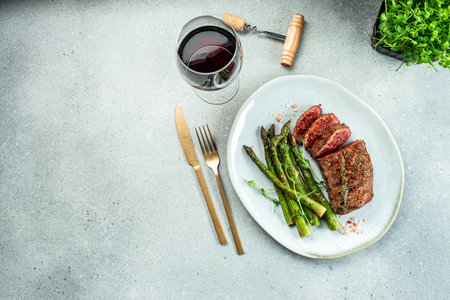 Barbecue steak with green asparagus and red wine. Healthy dinner or lunch.の写真素材