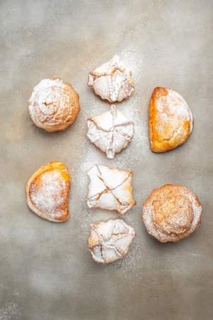 muffins and cupcakes sprinkled with powdered sugar, vertical image. top view. place for text.の写真素材