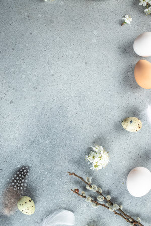 Easter composition with a willow branch and eggs on a blue background. vertical image. top view. place for text.の写真素材