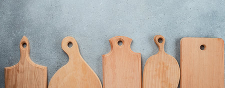 Set of different cutting wooden boards on light background. Collection of boards. Long banner format. top view.の写真素材