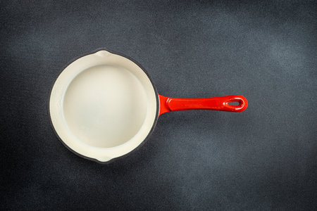 frying pan with red and white on dark concrete background. food cooking background. top view,の写真素材