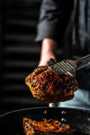 juicy delicious beef steak on a dark background. vertical image. top view. place for text.の写真素材