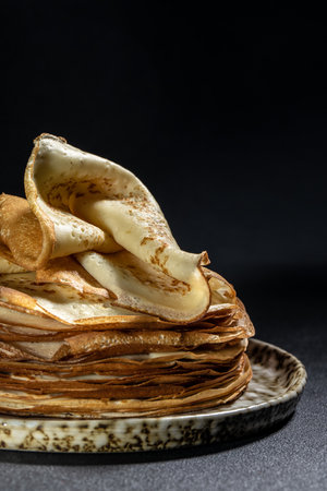 Crepes on plate. Homemade thin fresh crepes for breakfast or dessert. vertical image. place for text.の写真素材
