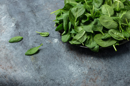 Fresh baby spinach leaves. Pile of fresh green baby spinach leaves, banner, menu, recipe place for text, top view.の写真素材