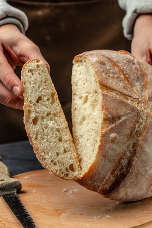 Homemade sourdough bread in hand. Healthy food concept. place for text, top view.