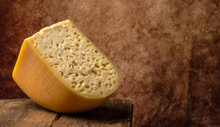 Emmental cheese triangle, Swiss cheese. piece of cheese maasdam with big holes. farmer market. banner, menu, recipe place for text.の写真素材