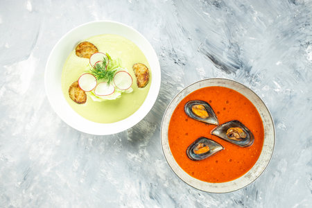 Set of vegetables soups tomato and zucchini on a light background. Delicious balanced food concept. top view.の写真素材