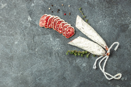 Traditional Spanish Fuet dried sausage on a light background. banner, menu, recipe place for text, top view.の写真素材