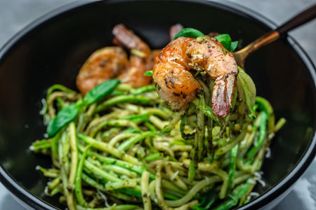 Pasta spaghetti zucchini basil pesto sauce and grilled shrimp, Vegetarian vegetable pasta, Restaurant menu, dieting, cookbook recipe top view.の写真素材