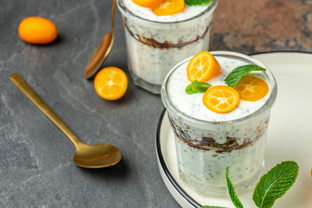 Chia pudding parfait, layered with kumquat and granola. breakfast. Healthy food concept. place for text.の写真素材