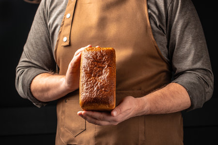 male hands holding bread. domestic cozy bakery pastry. Healthy food concept. place for text.